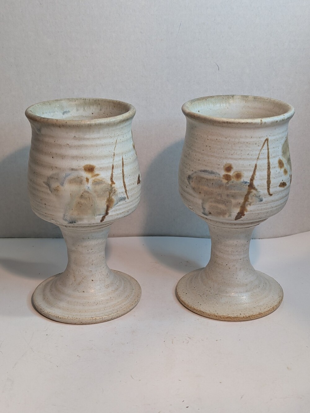 A pair of handcrafted studio art pottery wine goblets.